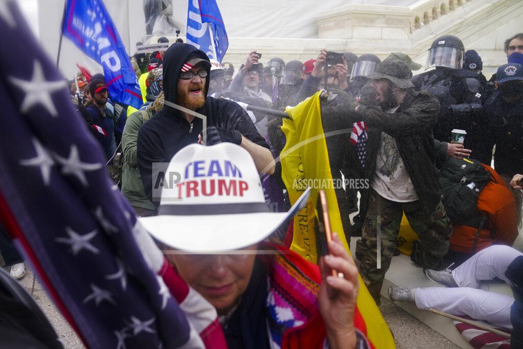John Minchillo FILE - In this Jan. 6, 2021, file photo rioters loyal to President Donald Trump try to break through a police barrier at the Capitol in Washington. Arguments begin Tuesday, Feb. 9, in the impeachment trial of Donald Trump on allegations that he incited the violent mob that stormed the U.S. Capitol on Jan. 6. (AP Photo/John Minchillo, File)