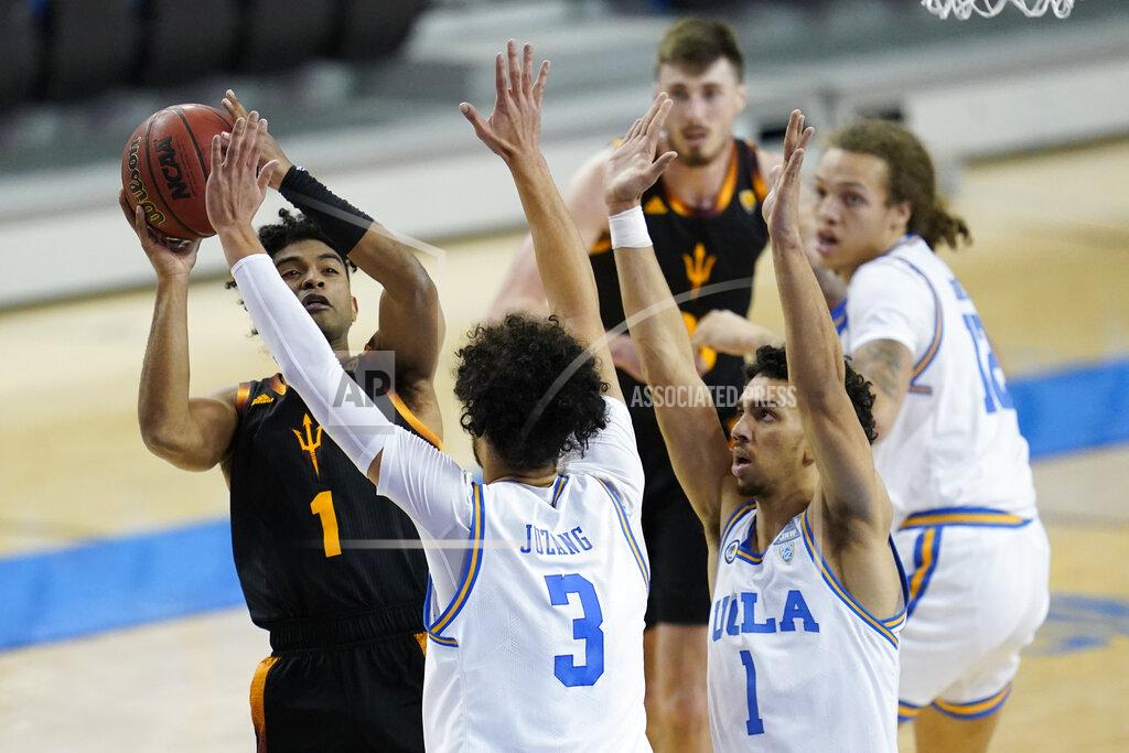 Ashley Landis Arizona State guard Remy Martin (1) shoots against UCLA guards Johnny Juzang (3) and Jules Bernard (1) during the first half of an NCAA college basketball game Saturday, Feb. 20, 2021, in Los Angeles. (AP Photo/Ashley Landis)