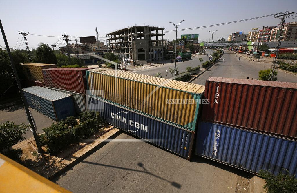 Anjum Naveed Shipping containers placed by authorities block a key highway to capital city in an attempt to foil a planned rally, in Islamabad, Pakistan, Wednesday, May 25, 2022. Pakistani authorities blocked off all major roads into the capital Islamabad on Wednesday, after a defiant former Prime Minister Imran Khan said he would march with demonstrators to the city center for a rally he hopes will bring down the government and force early elections.(AP Photo/Anjum Naveed)