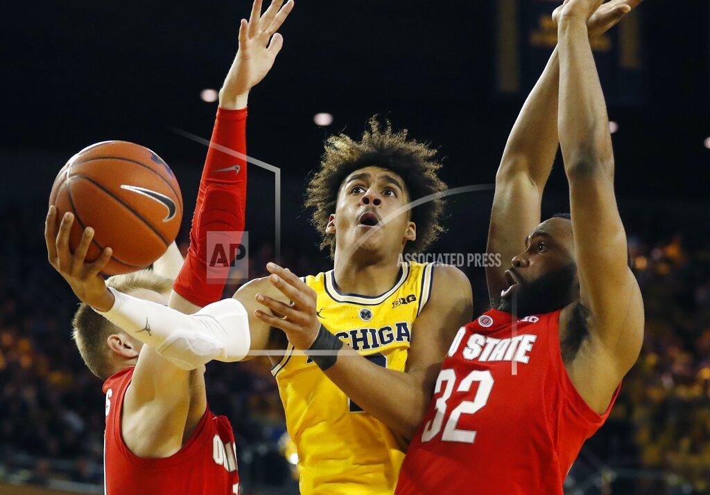 Carlos Osorio Michigan guard Jordan Poole (2) scores between Ohio State forward Justin Ahrens, left, and guard Keyshawn Woods during the second half of an NCAA college basketball game Tuesday, Jan. 29, 2019, in Ann Arbor, Mich. (AP Photo/Carlos Osorio)
