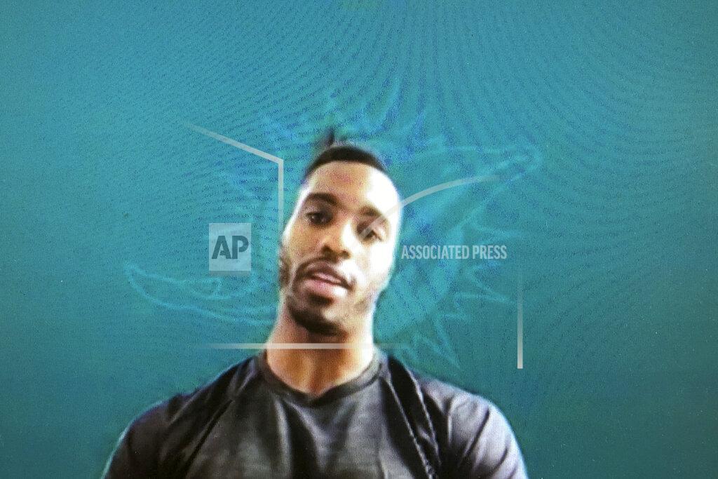 Miami Dolphins NFL football player Byron Jones is shown during a Zoom news conference in this photo made in Miami Lakes, Fla., Thursday, March 26, 2020. The Miami Dolphins practiced safe distancing when they introduced eight newly acquired players hunkered down around the country, holding a series of news conferences via Zoom. The technology changed the dynamics of the conversation, and players seemed to like it. (AP Photo/Steve Wine)