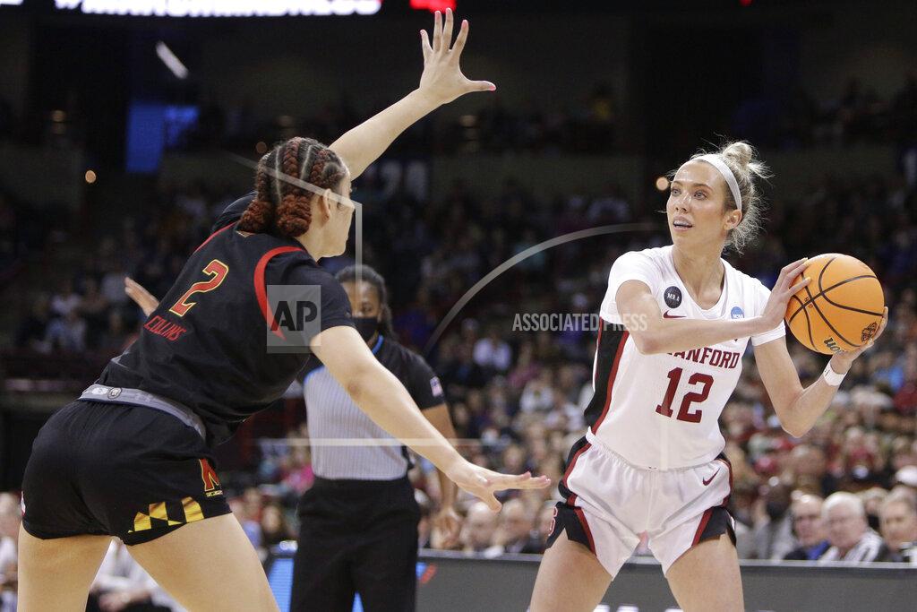 Young Kwak Stanford guard Lexie Hull (12) passes around the defense of Maryland forward Mimi Collins (2) during the first half of a college basketball game in the Sweet 16 round of the NCAA tournament, Friday, March 25, 2022, in Spokane, Wash. (AP Photo/Young Kwak)