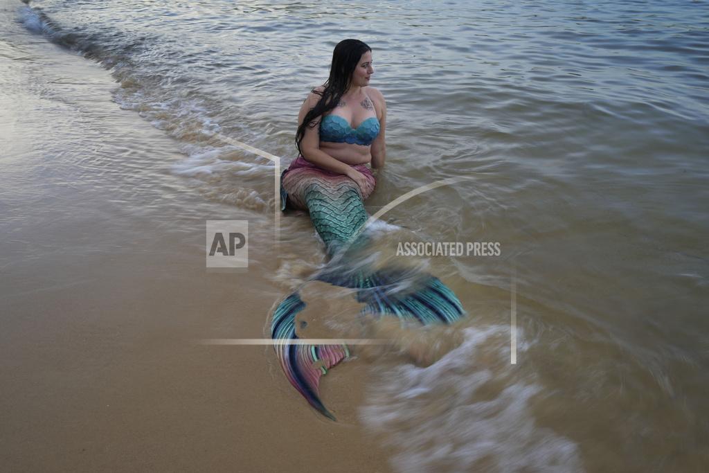 Mark Baker Lauren Metzler, founder of Sydney Mermaids, prepares for a swim at Manly Cove Beach in Sydney, Australia, Thursday, May 26, 2022. “The more we open up our imagination and accept everyone for how they are, it makes it more of a beautiful experience,” she says. “The sky _ or ocean floor _ is the limit of what you can do with mermaiding.” (AP Photo/Mark Baker)