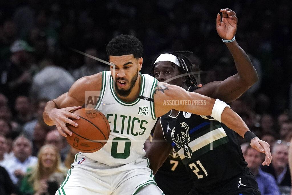 Charles Krupa Boston Celtics forward Jayson Tatum (0) tries to pivot around Milwaukee Bucks guard Jrue Holiday (21) during the first half of Game 5 of an Eastern Conference semifinal in the NBA basketball playoffs, Wednesday, May 11, 2022, in Boston. (AP Photo/Charles Krupa)