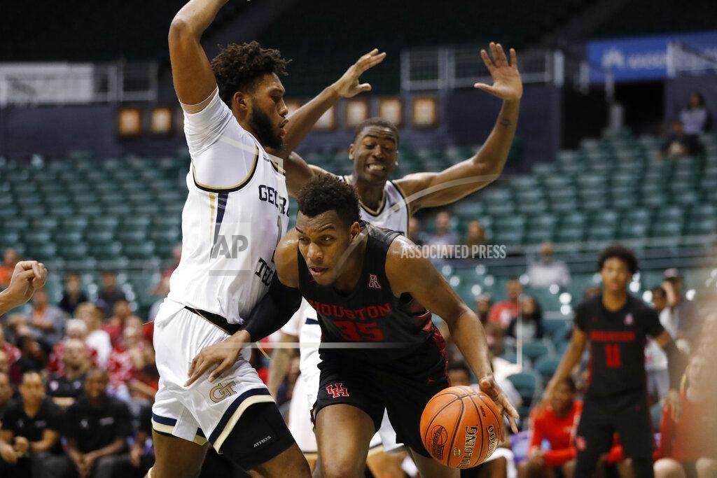 Marco Garcia After grabbing a rebound, Houston forward Fabian White Jr. (35) tries to get past Georgia Tech forwards James Banks III. left, and Moses Wright during the second half of an NCAA college basketball game Monday, Dec. 23, 2019, in Honolulu. (AP Photo/Marco Garcia)