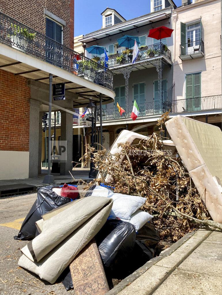 Stacey Plaisance Debris from Hurricane Ida sits on a curb beneath balconies in the French Quarter in New Orleans on Thursday, Sept. 2, 2021. With nearly all the power back on in New Orleans nearly two weeks after Ida stuck, the city is showing signs of making a comeback from the Category 4 killer. (AP Photo/Stacey Plaisance)