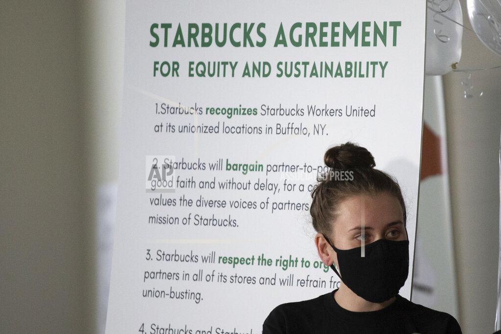 Joshua Bessex FILE - Alexis Rizzo, a Starbucks employee, stands during a press conference after their union-election viewing party Thursday, Dec. 9, 2021, in Buffalo, N.Y. It’s become a common sight: jubilant Starbucks workers celebrating after successful votes to unionize at dozens of U.S. stores. But when the celebrations die down, a daunting hurdle remains. To win the changes they seek, like better pay and more reliable schedules, unionized stores must sit down with Starbucks and negotiate a contract. It’s a painstaking process that can take years. (AP Photo/Joshua Bessex, File)