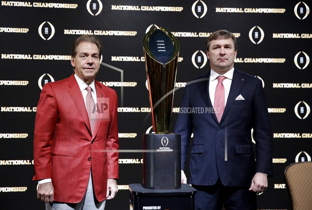 FILE - In this Jan. 7, 2018, file photo, Alabama head coach Nick Saban, left, and Georgia head coach Kirby Smart pose with the NCAA college football championship trophy at a press conference in Atlanta. Neither No. 1 Alabama nor No. 4 Georgia is anxiously awaiting their playoff fates this season, but whoever wins the SEC championship game showdown is definitely in the playoffs. The Crimson Tide could even get in with a close loss. (AP Photo/David Goldman, File)