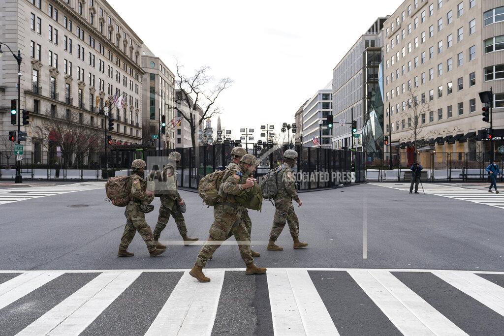 Alex Brandon U.S. Army National Guard soldiers walk along K Street near Black Lives Matter Plaza, Tuesday, Jan. 19, 2021, in Washington. (AP Photo/Alex Brandon)