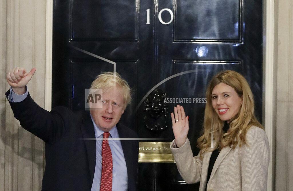 Matt Dunham In this Friday, Dec. 13, 2019, file photo, Britain's Prime Minister Boris Johnson and his partner Carrie Symonds wave from the steps of number 10 Downing Street in London. U.K. newspapers are reporting that Prime Minister Johnson and his fiancée Symonds married Saturday, May 29, 2021, in a small private ceremony in London. The Mail on Sunday and the Sun said the couple wed at the Roman Catholic Westminster Cathedral in front of a small group of friends and family. (AP Photo/Matt Dunham, File)