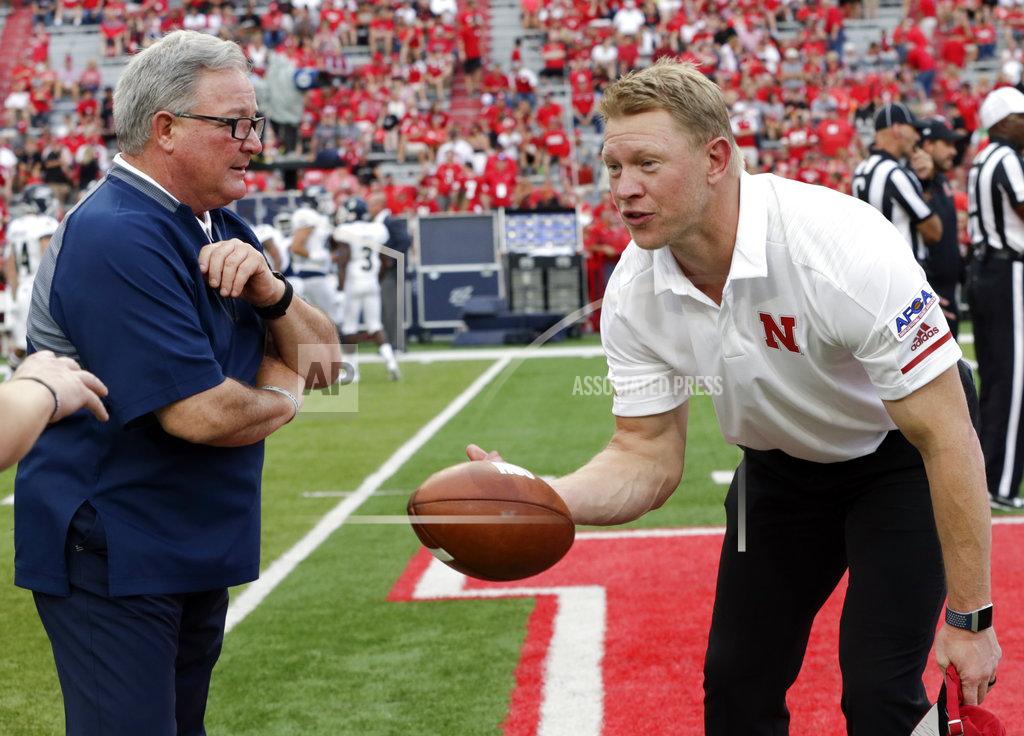 Nati Harnik Nebraska head coach Scott Frost, right, tosses the football back to players while talking with Akron head coach Terry Bowden before an NCAA college football game in Lincoln, Neb., Saturday, Sept. 1, 2018. (AP Photo/Nati Harnik)