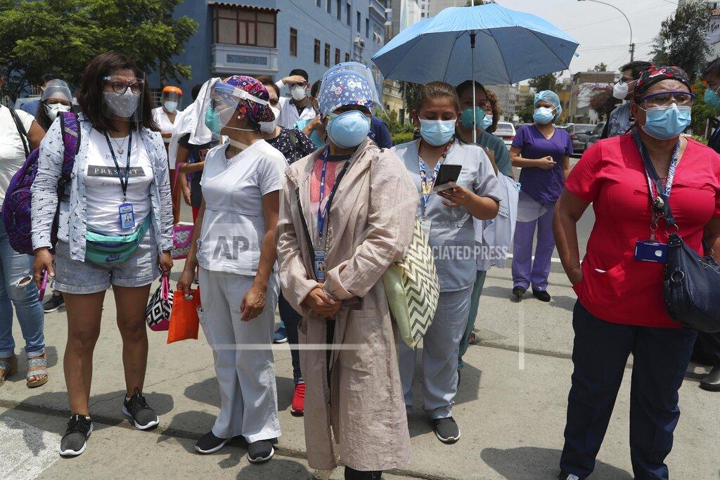 Martin Mejia Medical workers who say they work directly with COVID-19 patients stand outside the public Rebagliati Hospital where they say work where other health workers get shots of China's Sinopharm vaccine during a priority vaccination campaign inside the facility in Lima, Peru, Wednesday, Feb. 10, 2021. The group complained that they are not on the list of medical workers to be vaccinated and that some people getting shots do not work directly with COVID-19 patients. (AP Photo/Martin Mejia)