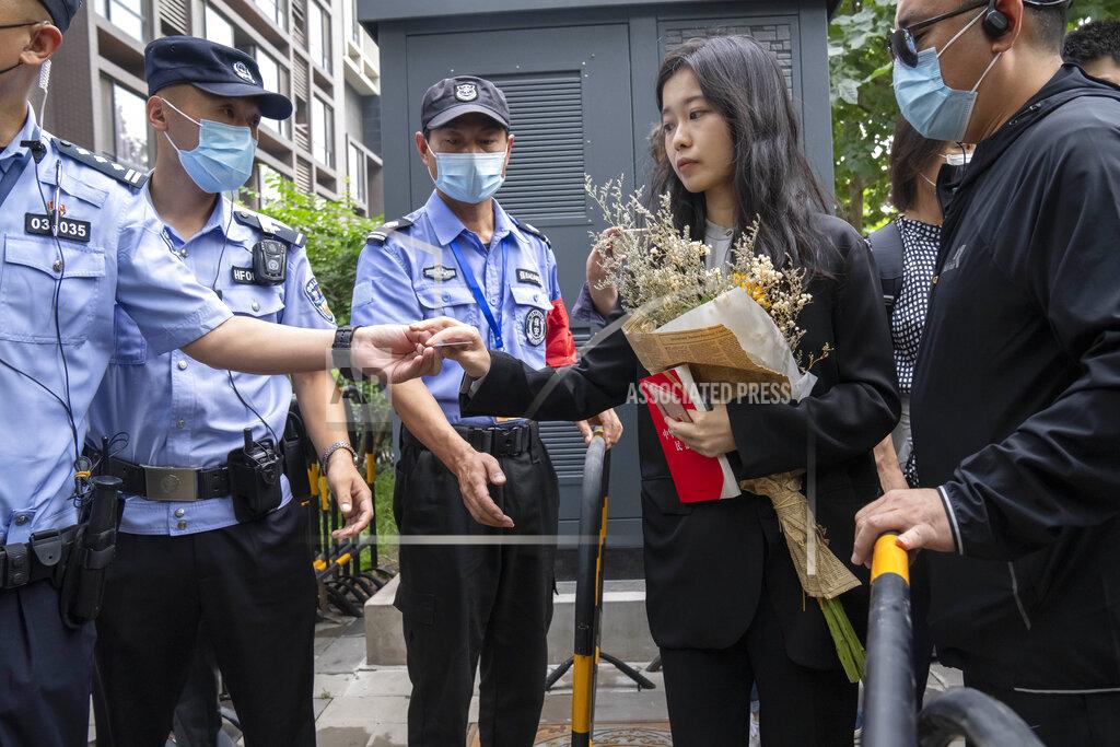 Mark Schiefelbein Zhou Xiaoxuan, a former intern at China's state broadcaster CCTV, has her identification checked at a barricade outside a courthouse in Beijing, Tuesday, Sept. 14, 2021. Zhou became the face of the country's MeToo movement after going public with accusations against a prominent CCTV host in 2018. Since then, even as the movement was shut down by authorities, Zhou has continued to speak out. (AP Photo/Mark Schiefelbein)