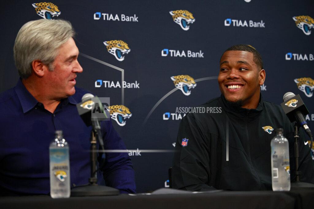 Corey Perrine Jacksonville Jaguars head coach Doug Pederson, left, looks to first round NFL football draft pick Travon Walker as they laugh at a press conference, Friday, April 29, 2022, at TIAA Bank Field in Jacksonville, Fla. (Corey Perrine/The Florida Times-Union via AP)