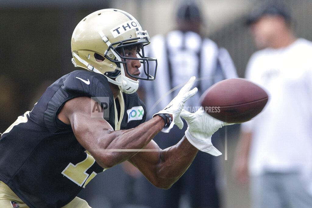 David Grunfeld New Orleans Saints wide receiver Michael Thomas (13) catches a New Orleans Saints quarterback Drew Brees (9) pass during an NFL football training camp practice at the Ochsner Sports Performance Center in Metairie, La., Friday, Aug. 28, 2020. (David Grunfeld/The Advocate via AP, Pool)
