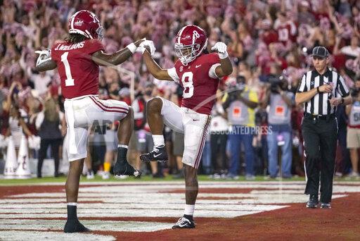 Alabama wide receivers Jameson Williams (1) and John Metchie III (8) celebrate Metchie's touchdown against Tennessee during the first half of an NCAA college football game Saturday, Oct. 23, 2021, in Tuscaloosa, Ala. (AP Photo/Vasha Hunt)