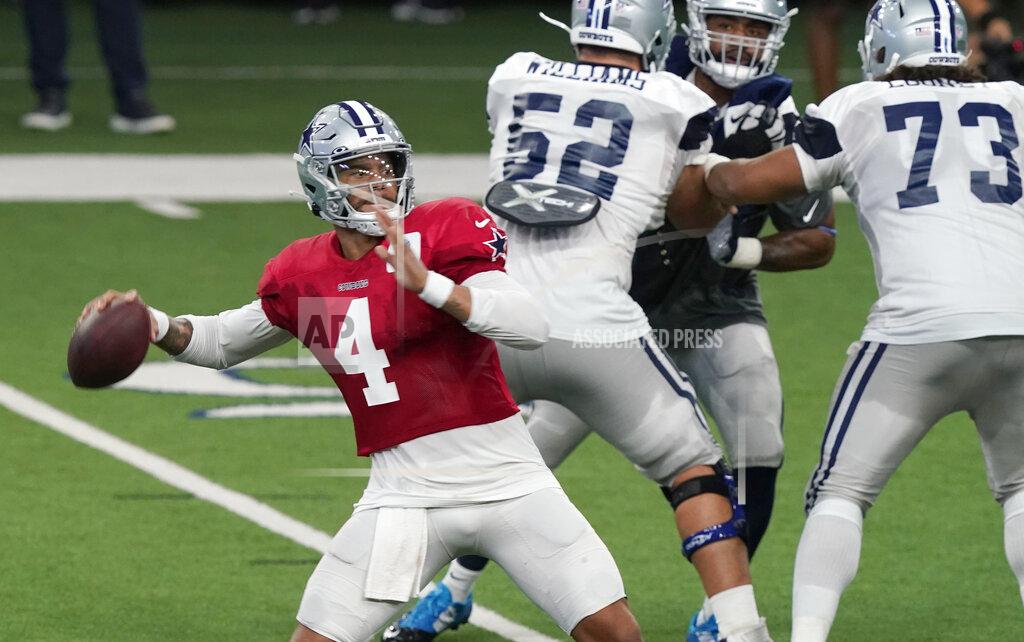 Lm Otero Dallas Cowboys quarterback Dak Prescott (4) passes with blocking by Connor Williams (52) and Joe Looney (73) during an NFL football training camp in Frisco, Texas, Monday, Aug. 24, 2020. (AP Photo/LM Otero)