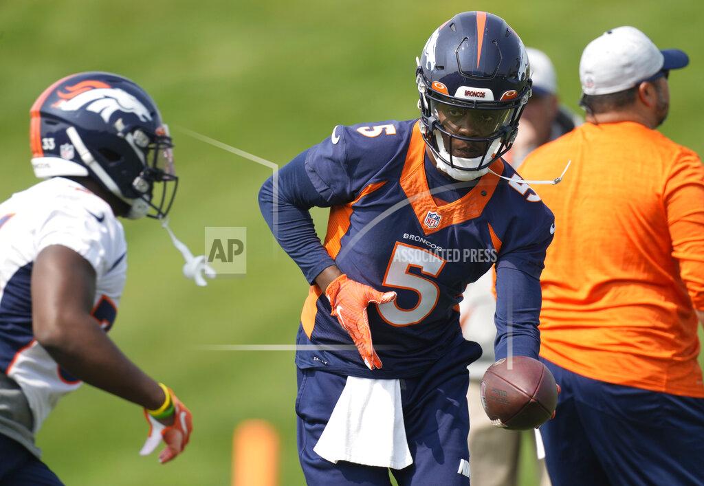 Denver Broncos quarterback Teddy Bridgewater, right, hands off the ball to running back Javonte Williams as they take part in drills during an NFL football training camp at the team's headquarters Tuesday, Aug. 10, 2021, in Englewood, Colo. (AP Photo/David Zalubowski)