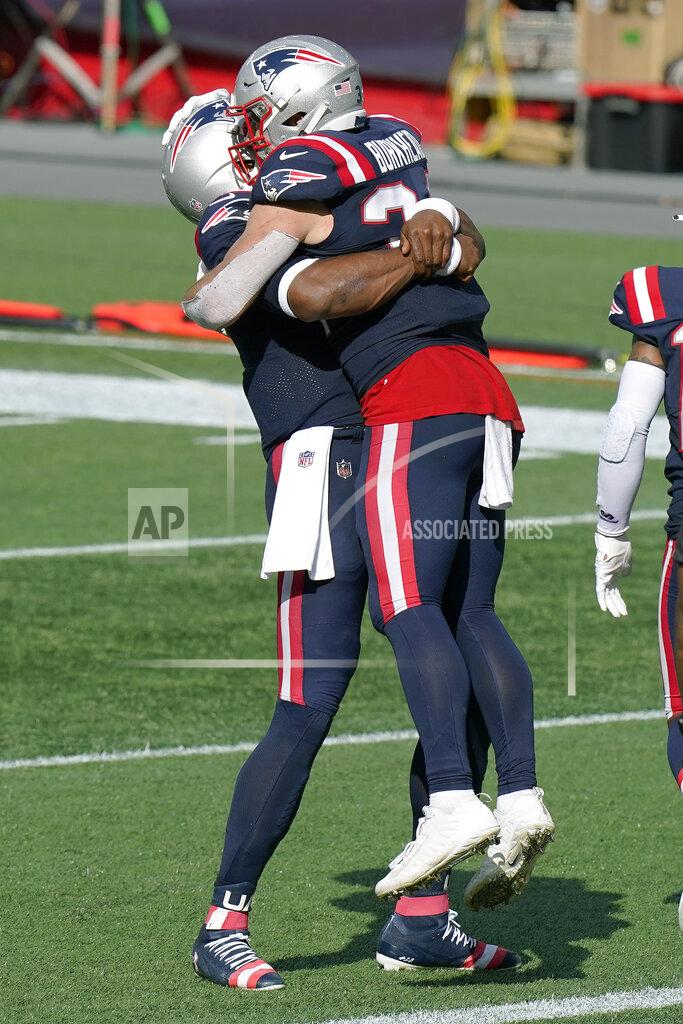 Steven Senne New England Patriots quarterback Cam Newton, left, gives running back Rex Burkhead a lift after Burkhead's touchdown in the second half of an NFL football game against the Las Vegas Raiders, Sunday, Sept. 27, 2020, in Foxborough, Mass. (AP Photo/Steven Senne)