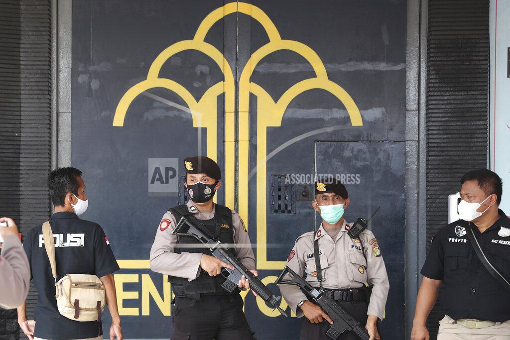 Tatan Syuflana Police officers guard at the main entrance gate of Tangerang prison in Tangerang on the outskirts of Jakarta, Indonesia, Wednesday, Sept. 8, 2021. A massive fire raged through the overcrowded prison early Wednesday, killing a number of inmates. (AP Photo/Tatan Syuflana)