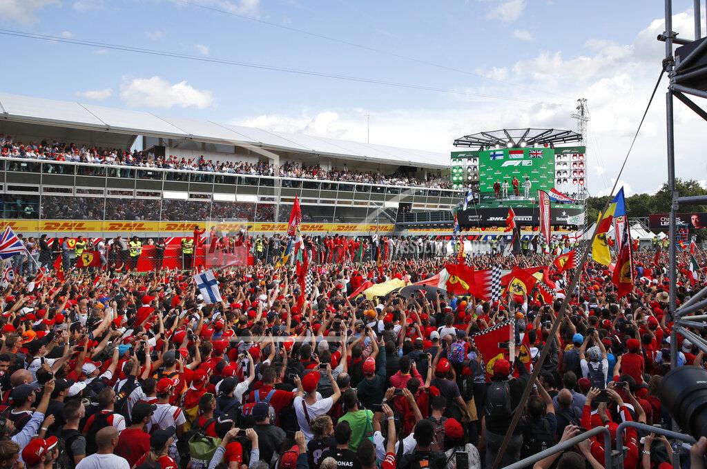 Antonio Calanni Ferrari fans celebrate under the podium after Ferrari driver Charles Leclerc of Monaco won the Formula One Italy Grand Prix at the Monza racetrack, in Monza, Italy, Sunday, Sept.8, 2019. (AP Photo/Antonio Calanni)