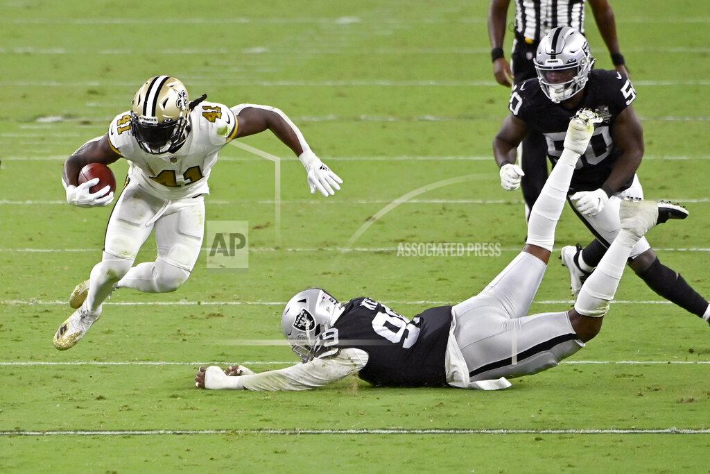 David Becker New Orleans Saints running back Alvin Kamara (41) avoids a tackle by Las Vegas Raiders defensive end Arden Key (99) during the second half of an NFL football game, Monday, Sept. 21, 2020, in Las Vegas. (AP Photo/David Becker)