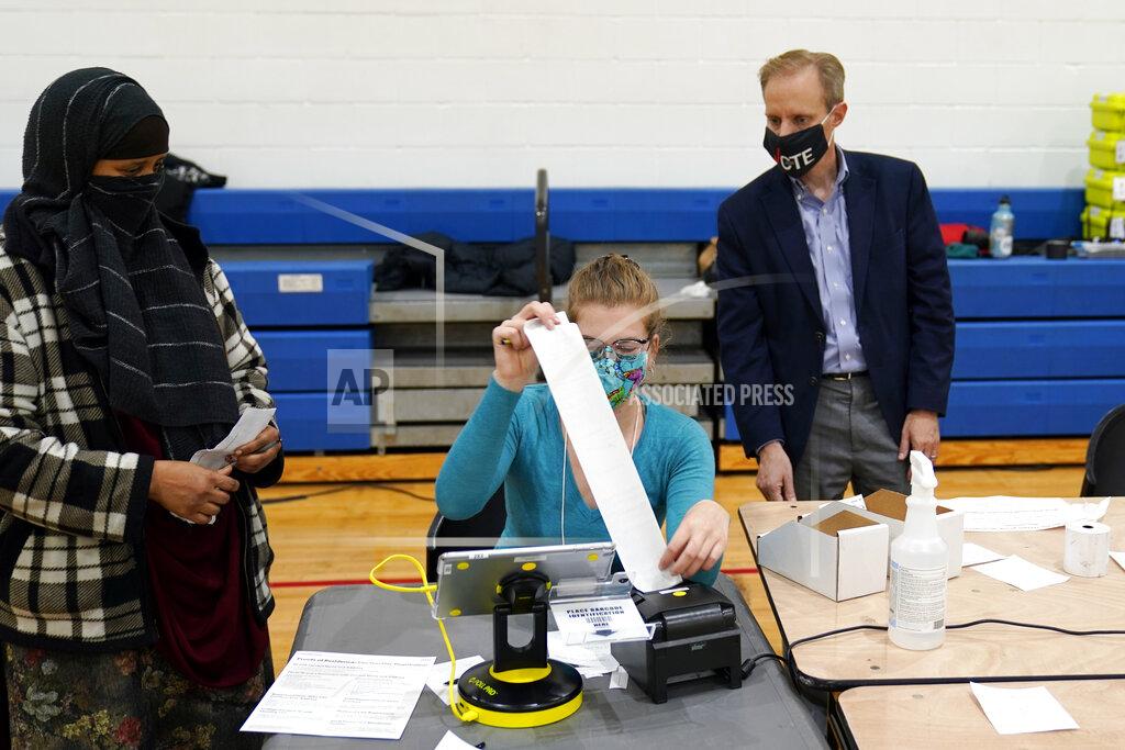 Jim Mone Minnesota Secretary of State Steve Simon visits with poll workers as he toured the Brian Coyle Center, on Election Day Tuesday, Nov. 3, 2020, in Minneapolis. (AP Photo/Jim Mone)