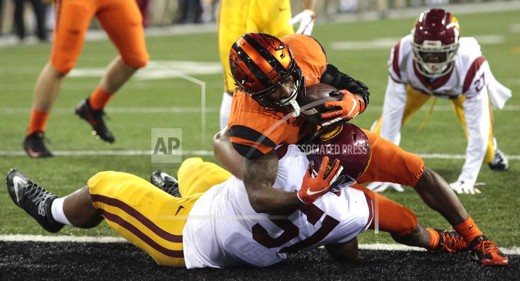 Timothy J. Gonzalez Oregon State's Artavis Pierce, top, bowls over Southern California's Marlon Tuipulotu (51) for a touchdown in the second half of an NCAA college football game in Corvallis, Ore., on Saturday, Nov. 3, 2018. Southern California won 38-21. (AP Photo/Timothy J. Gonzalez)