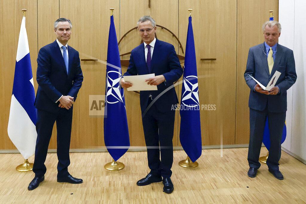 Johanna Geron Finland's Ambassador to NATO Klaus Korhonen, left, NATO Secretary-General Jens Stoltenberg and Sweden's Ambassador to NATO Axel Wernhoff attend a ceremony to mark Sweden's and Finland's application for membership in Brussels, Belgium, Wednesday May 18, 2022. NATO Secretary-General Jens Stoltenberg said that the military alliance stands ready to seize a historic moment and move quickly on allowing Finland and Sweden to join its ranks, after the two countries submitted their membership requests. (Johanna Geron, Pool via AP)