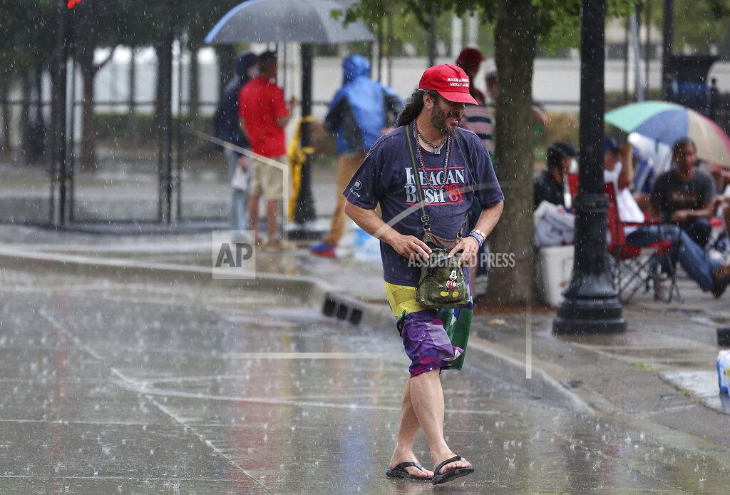Mike Simons A heavy rain falls as Trump supporters line up and camp on 4th Street between Boulder Ave. and Cheyenne Ave. in downtown Tulsa, Okla., ahead of President Donald Trump's Saturday's campaign rally Friday, June 19, 2020. (Mike Simons/Tulsa World via AP)