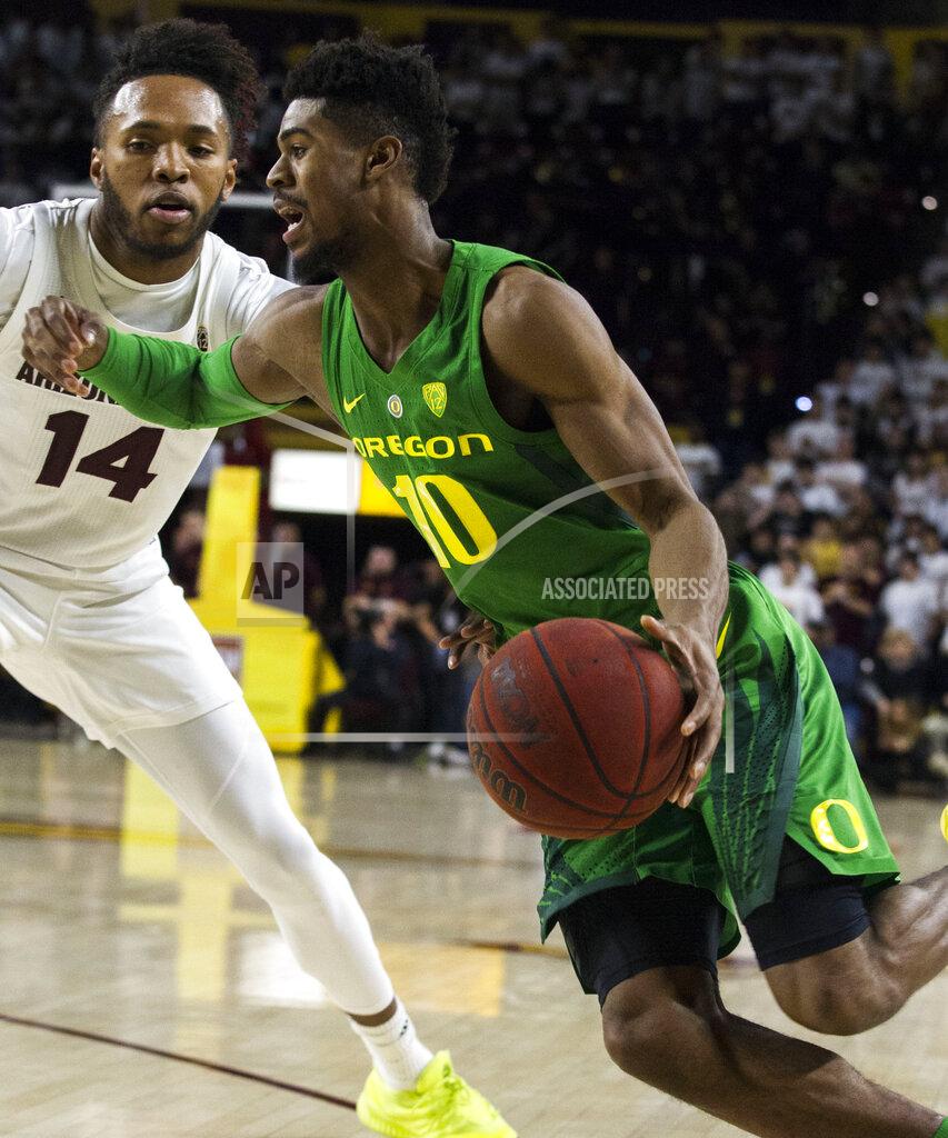Darryl Webb Oregon's Victor Bailey Jr. (10) drives around Arizona State's Kimani Lawrence (14) during the first half of an NCAA college basketball game Saturday, Jan. 19, 2019, in Tempe, Ariz. (AP Photo/Darryl Webb)