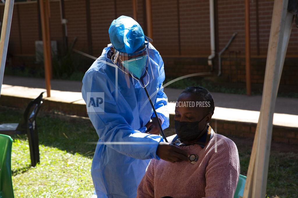 Denis Farrell A woman is screened for COVID-19 at a testing centre in Soweto, South Africa, Wednesday, May 11, 2022. Health experts in South Africa say the country is experiencing a surge of new COVID-19 cases driven by two omicron sub-variants. Professor Marta Nunes, a researcher at Vaccine and Infectious Diseases Analytics at Chris Hani Baragwanath Hospital in Soweto said that for about three weeks the country has seen increasing numbers of new cases and somewhat higher hospitalizations, but not increases in severe cases and deaths. (AP Photo/Denis Farrell)