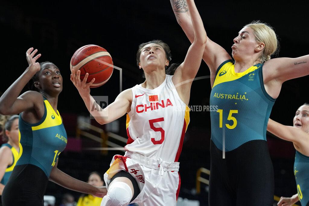 Eric Gay China's Siyu Wang (5) drives on Australia's Cayla George (15) during a women's basketball preliminary round game at the 2020 Summer Olympics in Saitama, Japan, Friday, July 30, 2021. (AP Photo/Eric Gay)
