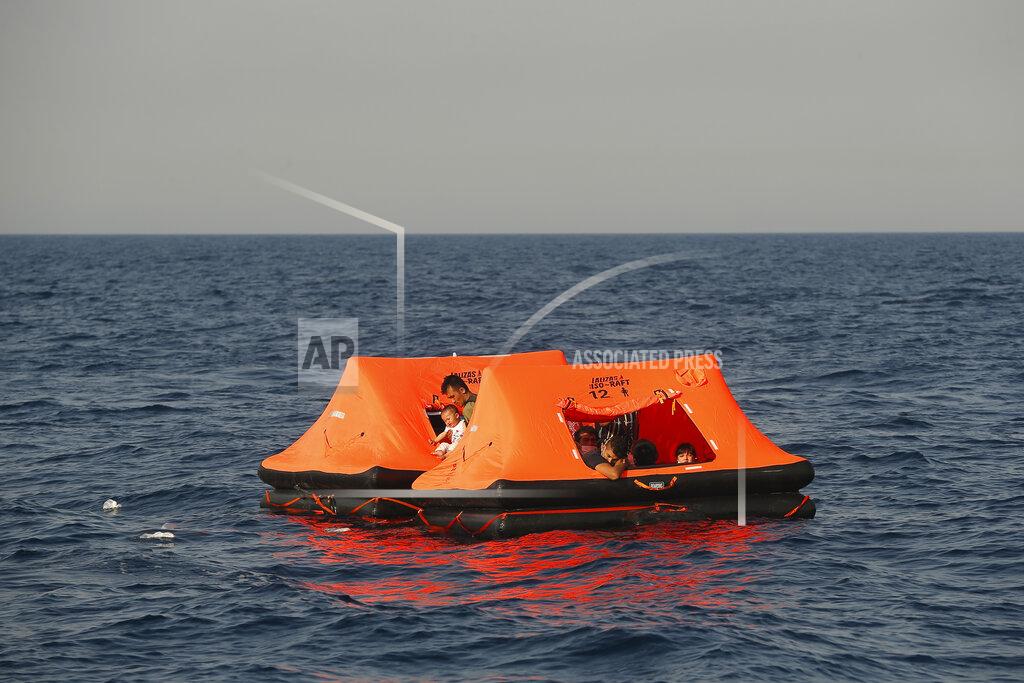 Emrah Gurel Afghan migrants watch from inside a life raft during a rescue operation by the Turkish coast guard, in the Aegean Sea, between Turkey and Greece, Saturday, Sept. 12, 2020. Turkey is accusing Greece of large-scale pushbacks at sea — summary deportations without access to asylum procedures, in violation of international law. The Turkish coast guard says it rescued over 300 migrants "pushed back by Greek elements to Turkish waters" this month alone. Greece denies the allegations and accuses Ankara of weaponizing migrants. (AP Photo/Emrah Gurel)