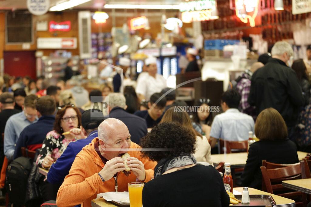 Seth Wenig FILE - In this May 11, 2017, file photo, diners enjoy eating at Katz's Delicatessen in New York. With New York City at the epicenter of the coronavirus outbreak in the U.S. and its native-born among those offering crucial information to the nation in televised briefings, the New York accent has stepped up to the mic — or maybe the megaphone. (AP Photo/Seth Wenig, File)
