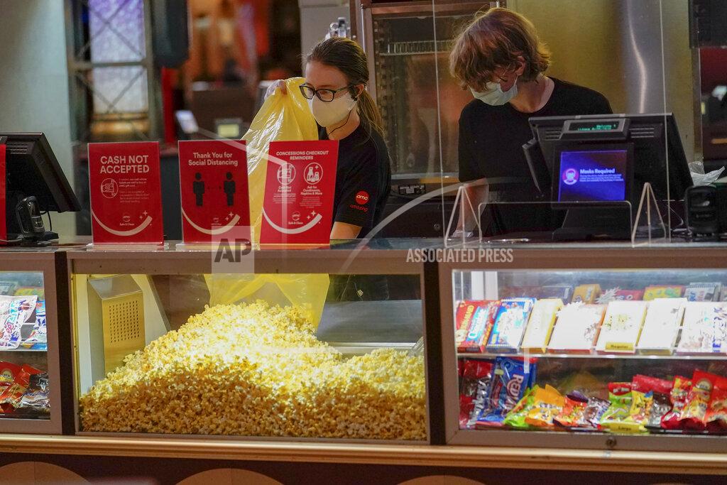 Keith Srakocic Concessions workers stock the bins with popcorn and other treats as the theatre opens for some of the first showings at the AMC theatre when it re-opened for the first time since shutting down at the start of the COVID-19 pandemic, Thursday, Aug. 20, 2020, in West Homestead, Pa. (AP Photo/Keith Srakocic)