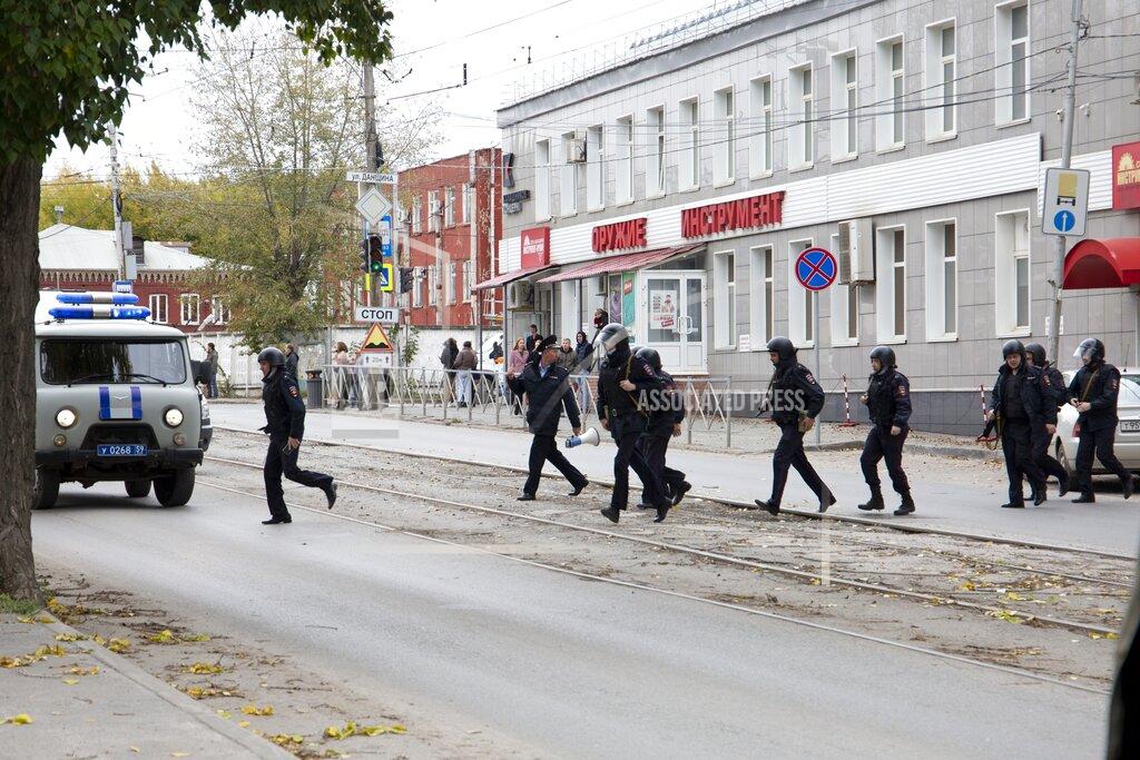 Anastasia Yakovleva Police officers run to the Perm State University in Perm, about 1,100 kilometers (700 miles) east of Moscow, Russia, Monday, Sept. 20, 2021. A gunman opened fire in a university in the Russian city of Perm on Monday morning, leaving around eight people dead and others wounded, according to Russia's Investigative Committee. (AP Photo/Anastasia Yakovleva)