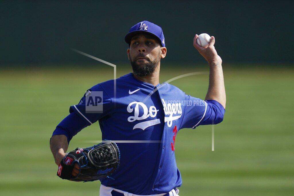 Ross D. Franklin Los Angeles Dodgers starting pitcher David Price throws a mock pitch as pitchers take infield drills during a spring training baseball practice Tuesday, Feb. 23, 2021, in Phoenix. (AP Photo/Ross D. Franklin)