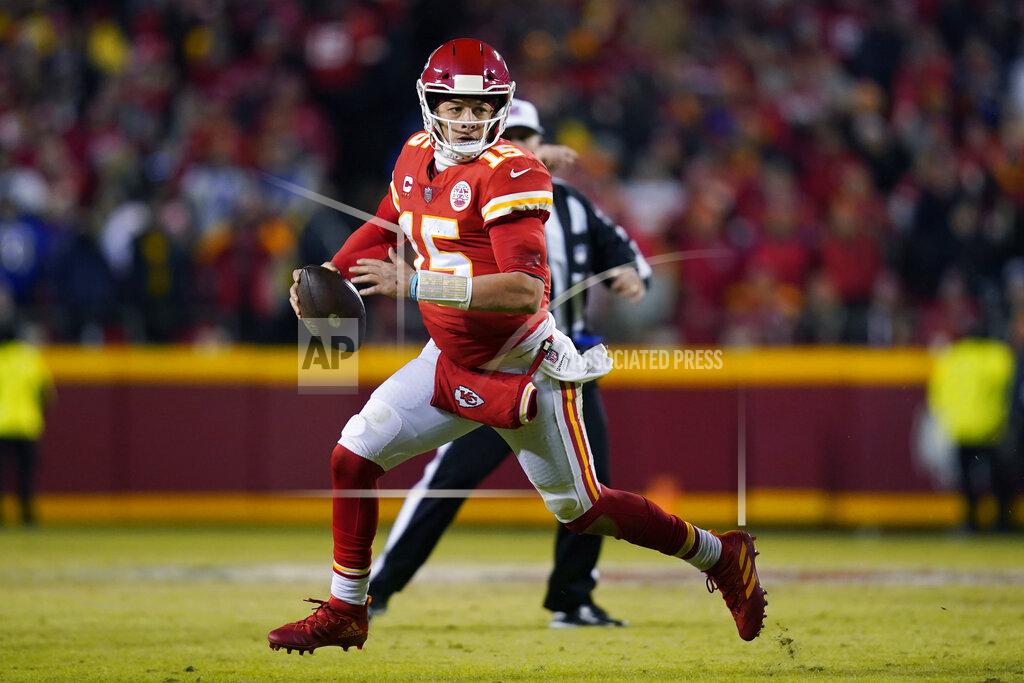Kansas City Chiefs quarterback Patrick Mahomes (15) scrambles up field during the second half of an NFL divisional round playoff football game against the Buffalo Bills, Sunday, Jan. 23, 2022, in Kansas City, Mo. (AP Photo/Ed Zurga)