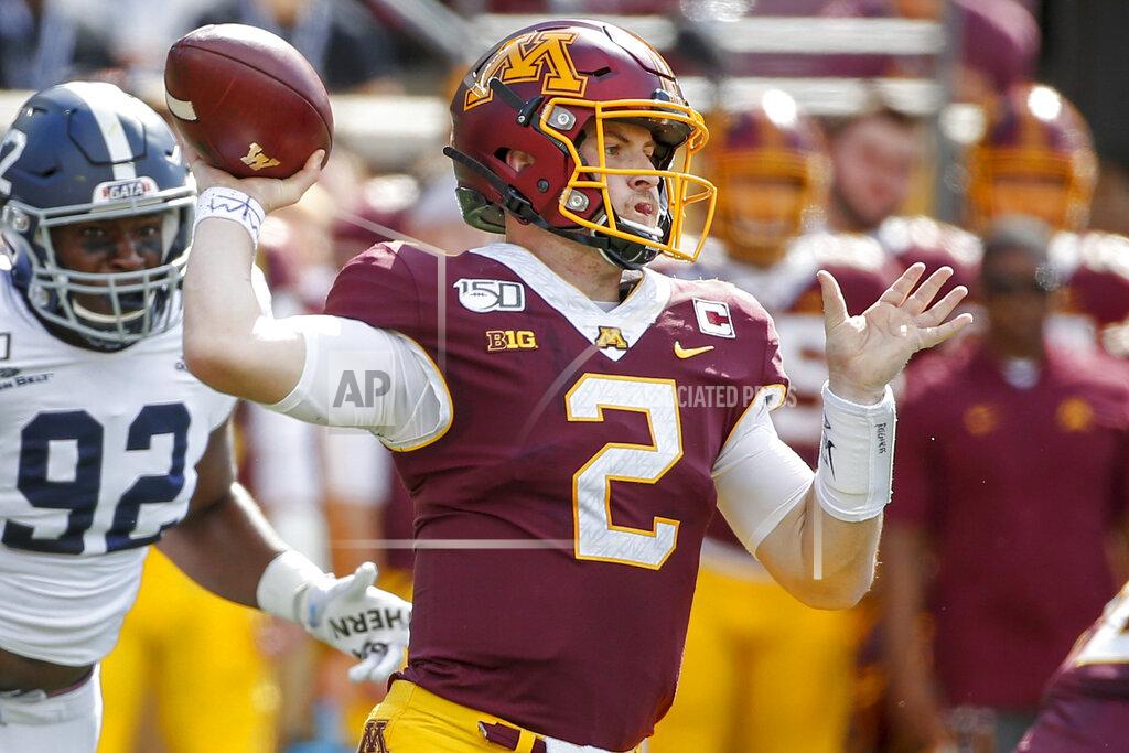 Bruce Kluckhohn FILE - In this Sept. 14, 2019, file photo, Minnesota quarterback Tanner Morgan (2) throws for a touchdown as Georgia Southern defensive end Raymond Johnson III (92) approaches during the first quarter of an NCAA college football game in Minneapolis. Morgan has zoomed to the top of the Big Ten leaders in passing, helping Minnesota start unbeaten after four games. Now the Gophers have an ugly loss to Illinois from last year to avenge. (AP Photo/Bruce Kluckhohn, File)