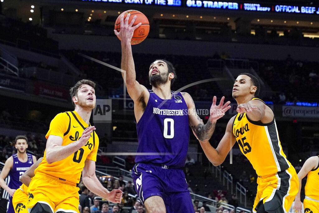 Michael Conroy Northwestern guard Boo Buie (0) shoots between Iowa forwards Filip Rebraca (0) and Keegan Murray (15) in the second half of an NCAA college basketball game at the Big Ten Conference tournament in Indianapolis, Thursday, March 10, 2022. Iowa defeated Northwestern 112-76. (AP Photo/Michael Conroy)