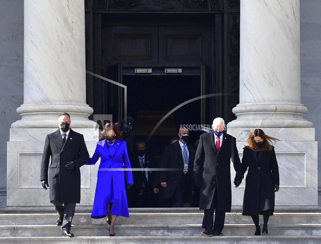 David Tulis Vice President Kamala Harris, husband Douglas Emhoff, former Vice President Mike Pence and Wife Karen Pence walk down the east side steps of the U.S. Capitol after the Presidential Inauguration in Washington on Wednesday, Jan. 20, 2021. (David Tulis/Pool Photo via AP)