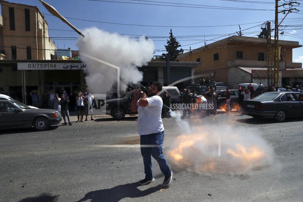 Bilal Hussein A Hezbollah supporter fires a rocket-propelled grenade in the air to celebrate the arrival of Iranian fuel tankers to Lebanon, in the eastern town of Baalbek, Lebanon, Thursday, Sept. 16, 2021. The delivery violates U.S. sanctions imposed on Tehran after former President Donald Trump pulled America out of a nuclear deal between Iran and world powers three years ago. (AP Photo/Bilal Hussein)