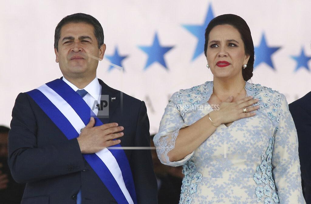 FILE - In this Jan. 27, 2018 file photo, Honduran President Juan Orlando Hernandez, left, stands with his wife Ana Garcia, during the presidential inauguration ceremony for his second term at the National Stadium in Tegucigalpa, Honduras. Hernández and his wife have tested positive for COVID-19, the Central American leader said late Tuesday, June 16, 2020, in a television message. (AP Photo/Fernando Antonio, File)