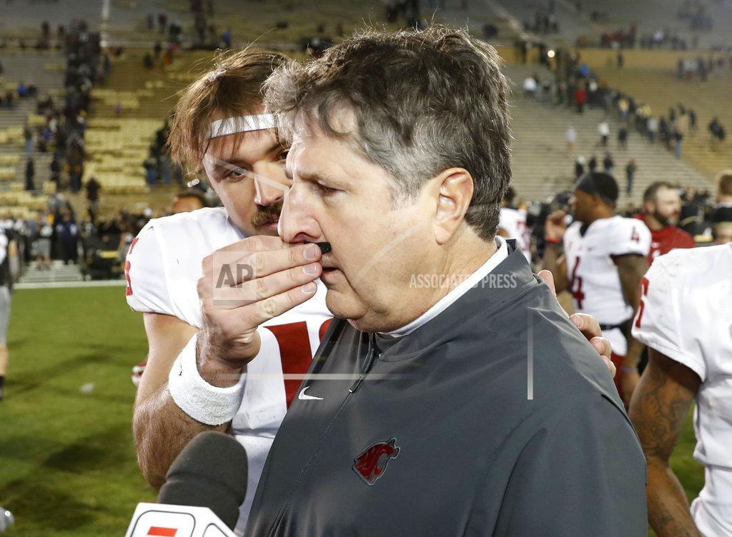 David Zalubowski Washington State quarterback Gardner Minshew, back, puts a fake mustache on head coach Mike Leach as he is interviewed after an NCAA college football game against Colorado Saturday, Nov. 10, 2018, in Boulder, Colo. Washington State won 31-7. (AP Photo/David Zalubowski)