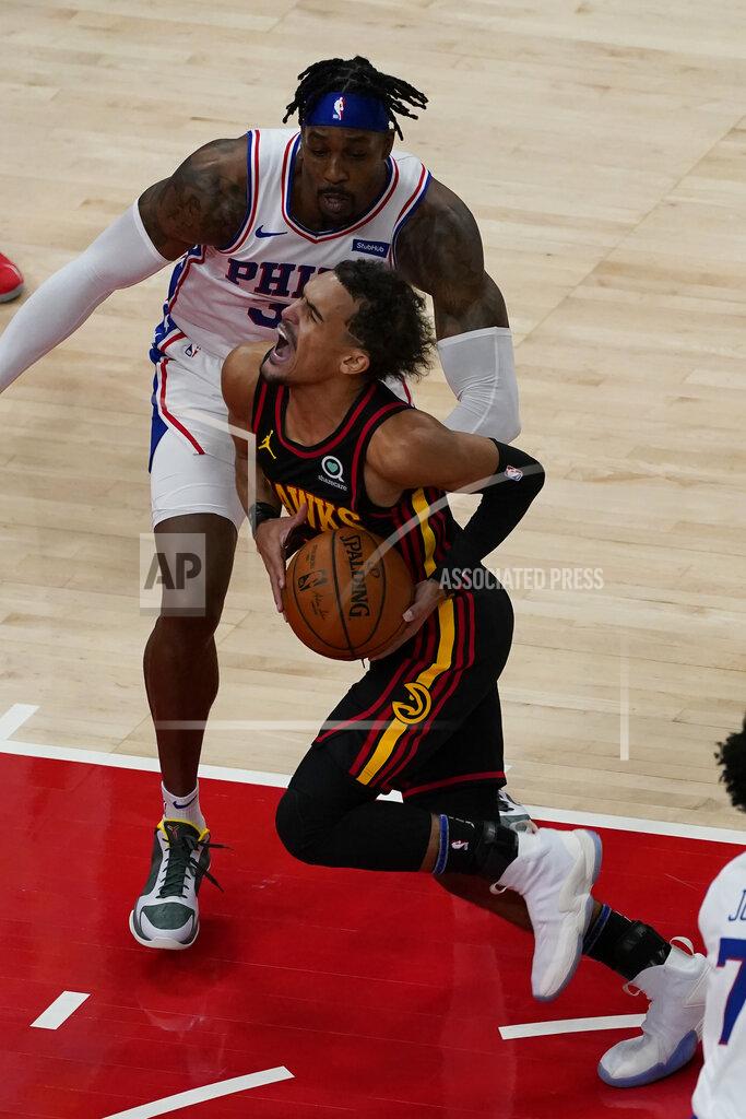 John Bazemore Atlanta Hawks guard Trae Young (11) drives against Philadelphia 76ers center Dwight Howard (39) during the first half of an NBA basketball game Monday, Jan. 11, 2021, in Atlanta. (AP Photo/John Bazemore)