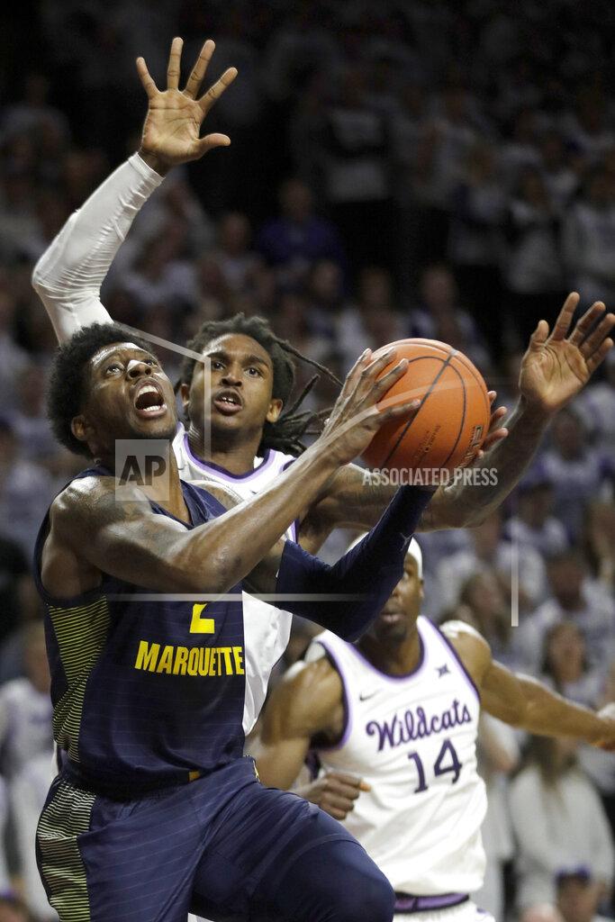 Orlin Wagner Marquette guard Sacar Anim (2) shoots after getting past Kansas State guard Cartier Diarra, back left, during the first half of an NCAA college basketball game in Manhattan, Kan., Saturday, Dec. 7, 2019. (AP Photo/Orlin Wagner)