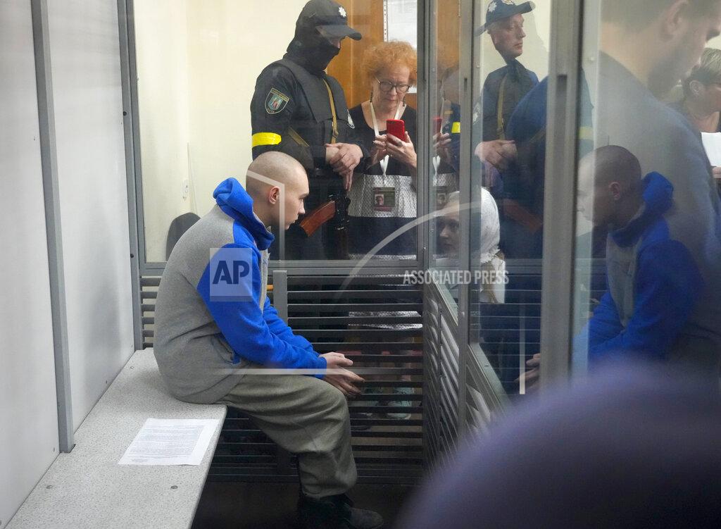 Efrem Lukatsky Russian army Sergeant Vadim Shishimarin, 21, is seen behind a glass during a court hearing in Kyiv, Ukraine, Friday, May 13, 2022. The trial of a Russian soldier accused of killing a Ukrainian civilian opened Friday, the first war crimes trial since Moscow's invasion of its neighbor. (AP Photo/Efrem Lukatsky)