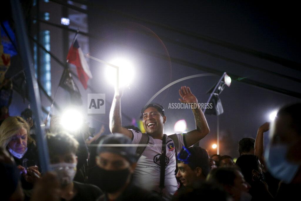 Luis Hidalgo People gather at Plaza Italia on the day Chileans voted in a referendum to decide whether the country should replace its 40-year-old constitution, written during the dictatorship of Gen. Augusto Pinochet, in Santiago, Sunday, Oct. 25, 2020. (AP Photo/Luis Hidalgo)