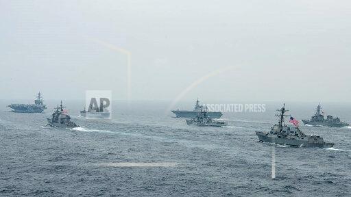 In this photo released by U.S. Navy, US Navy aircraft carrier USS Carl Vinson (CVN 70) and other US and Allies vessels transit the Bay of Bengal as part of MALABAR 2021, on Oct. 12, 2021. China seeks to bring the strategically and symbolically important island back under its control, and the U.S. sees Taiwan in the context of broader challenges from China. (Russel Lindsey/US Navy via AP)